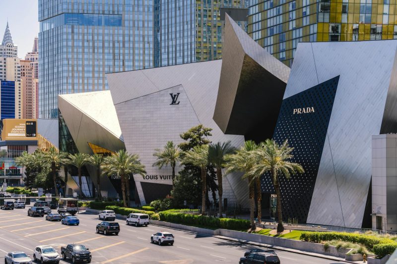 Modern Prada storefront on the Las Vegas Strip, featuring iconic city architecture in the background.