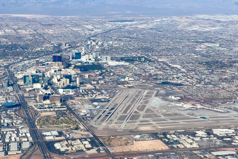 Aerial view of Las Vegas showcasing the airport and the vibrant city skyline.