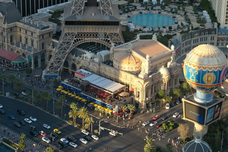 Aerial view of the Paris Las Vegas Hotel featuring the Eiffel Tower replica and busy streets below.