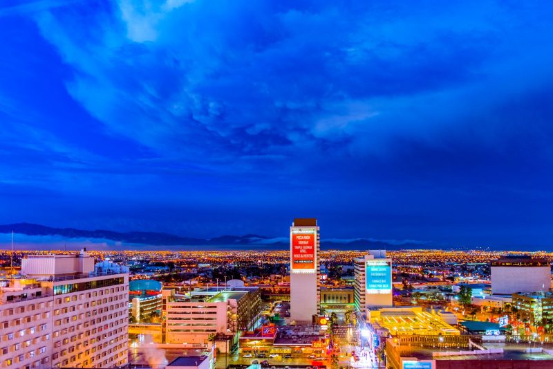 Illuminated Las Vegas skyline at night, featuring vibrant city lights and iconic buildings.