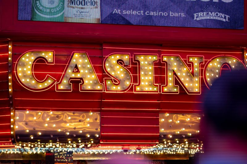 Brightly lit casino sign glowing at night in a vibrant Las Vegas city atmosphere.