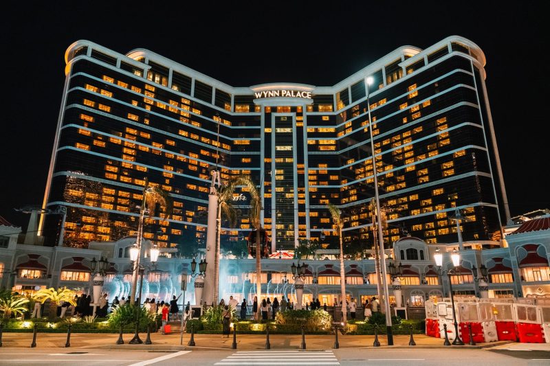 Illuminated Wynn Palace hotel and casino against a night sky in Macau.