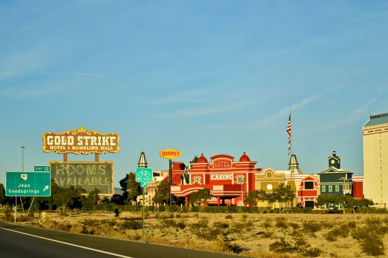 Vibrant architecture of the Gold Strike Hotel and Casino in Las Vegas against a clear blue sky.