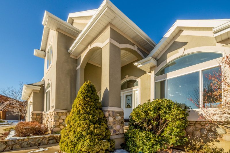 Elegant modern suburban house with a landscaped front yard, showcasing a bright and inviting exterior.